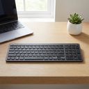 Teclado Inalámbrico Cygna Slim Grafito - a minimalist office desk with a laptop and a