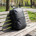 Mochila Viaje Impermeable Notebook 30L - on a wooden bench in a city park, daylight