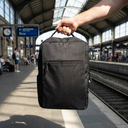 Mochila para Notebook con Puerto USB 1 - held in hand at a train station, natural lig