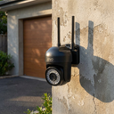 Cámara de Seguridad Impermeable Wifi 5 - on a garage exterior wall, afternoon light
